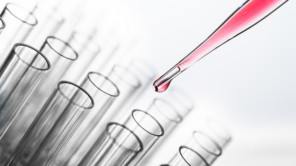 Drop the pink chemicals into the beaker. in vitro